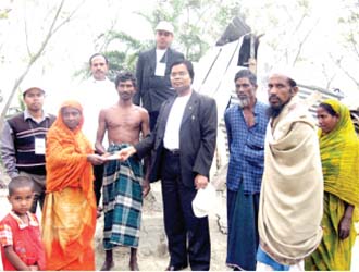 Secretary General of CSDC M Helal is handing over relief  money among homeless & distressed people of Barguna (2007)