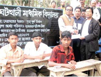 Campus Editor M Helal is handing over a cheque of Tk. 50,000 to Head Master of Ghotkhali High School as a token of co-operation to rebuild the school. (2007)