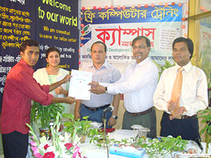 Press Secretary of Prime Minister, Freedom Fighter AKM Shamim Chowdhury is giving Certificates to the Trainees of Free Computer Training (Batch 92) as Chief Guest; Dr. M Helal presides over. (2009)