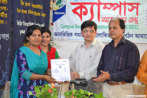 Senior Consultant in Cardiology of LabAid Hospital, Dr. A P M Sohrabuzzaman and Director of Bangladesh Television, Golam Sofiuddin, is giving Certificates to the Trainees of Free Computer Training (Batch 122+123); Dr. M Helal is presiding over. (2013)