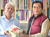 Dr. M Helal is handing over Creative Books and Models of Campus Publications to             Secretary-General of BAIRA and Founder of Prantik Group, Ghulam Mustafa (2018)