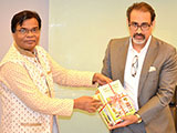 Dr. M Helal is handing over Creative Books and Models of Campus Publications to Managing Director of A K Group, A K Khan (2018)